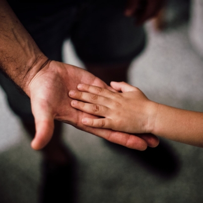 father and child s hands together